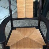 Pair of vintage 1950s Neo-Basque oak armchairs with straw seats and backs.