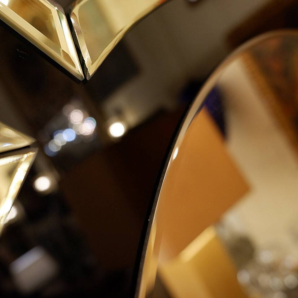 Pair of black and gold glass mirrors