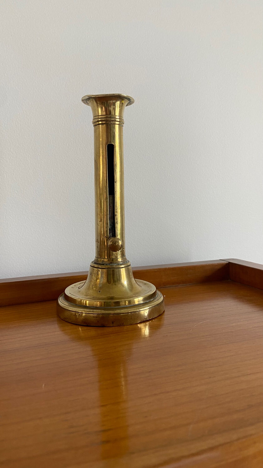 Old brass push candle holder