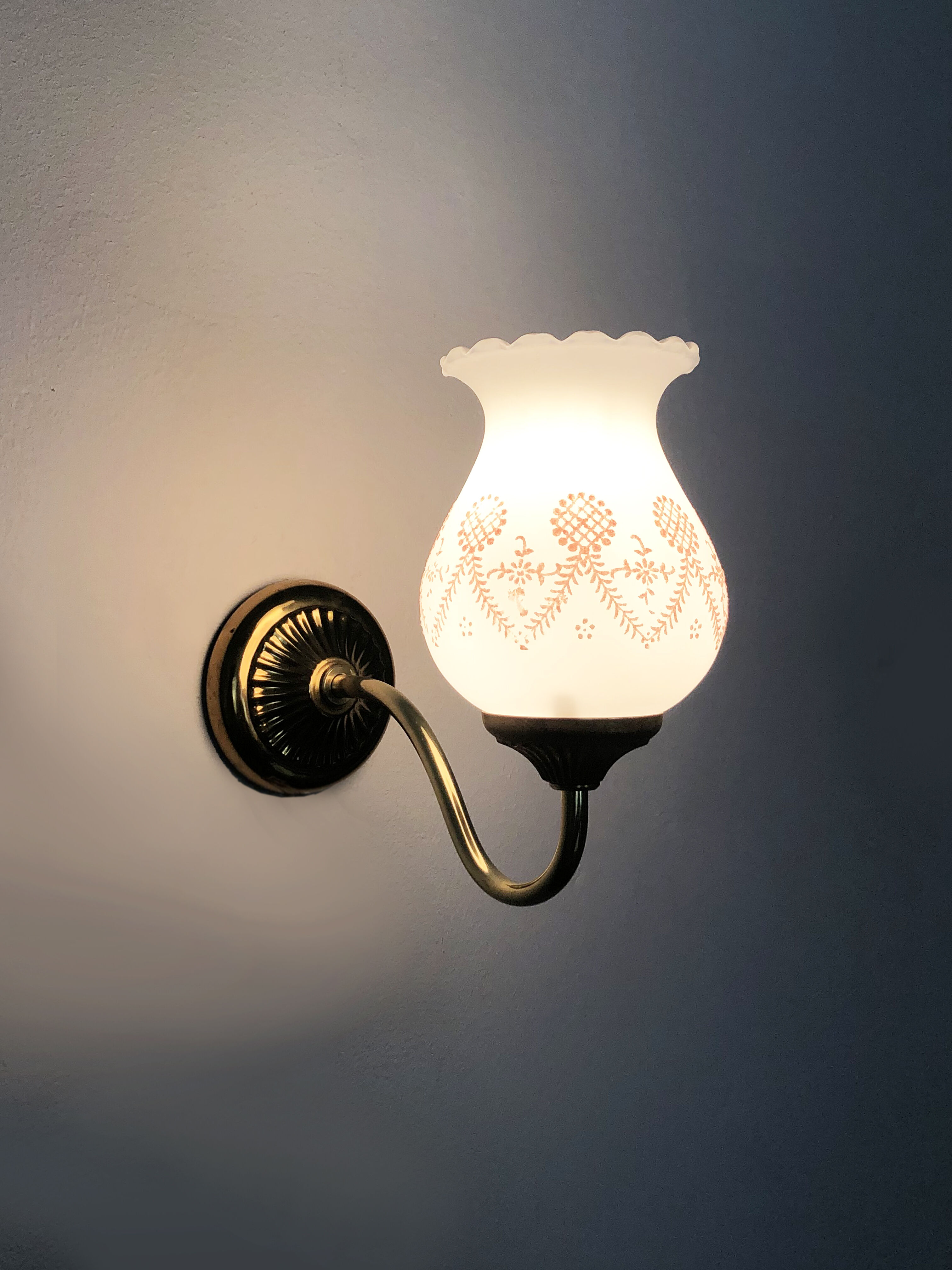 Pair of gooseneck wall sconces in gilded metal, white opaline with pink decorations