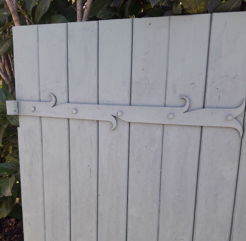 Pair of wooden shutters hanging iron