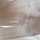 4 crystal champagne flutes with feet decorated with two knots.