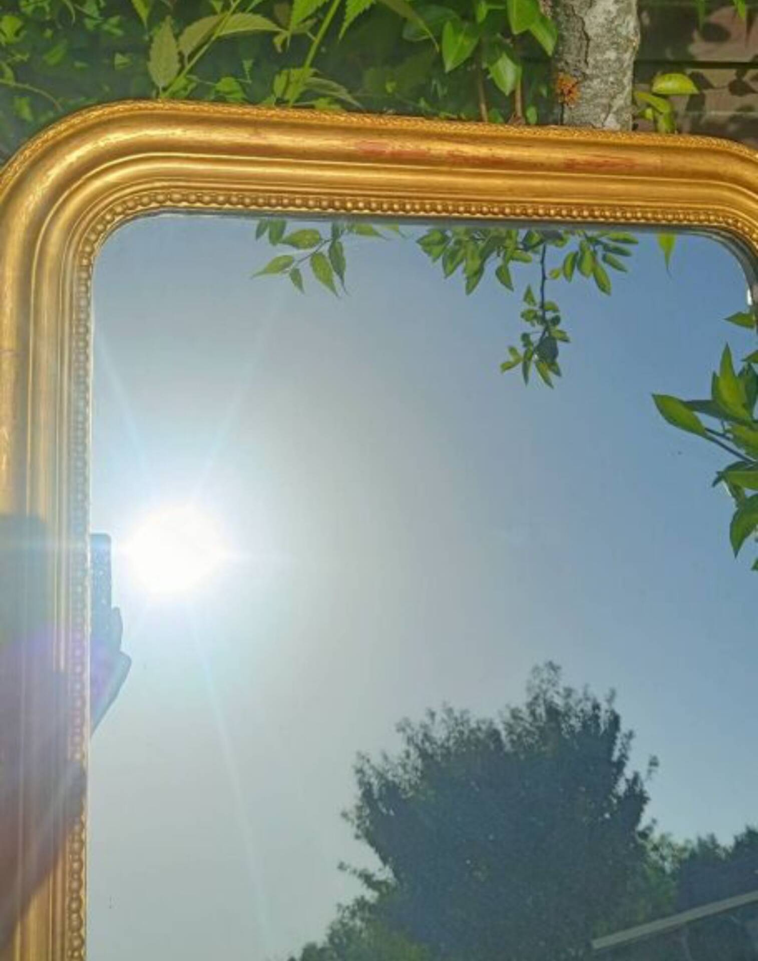 Antique Louis-Philippe mirror, gilded and patinated.