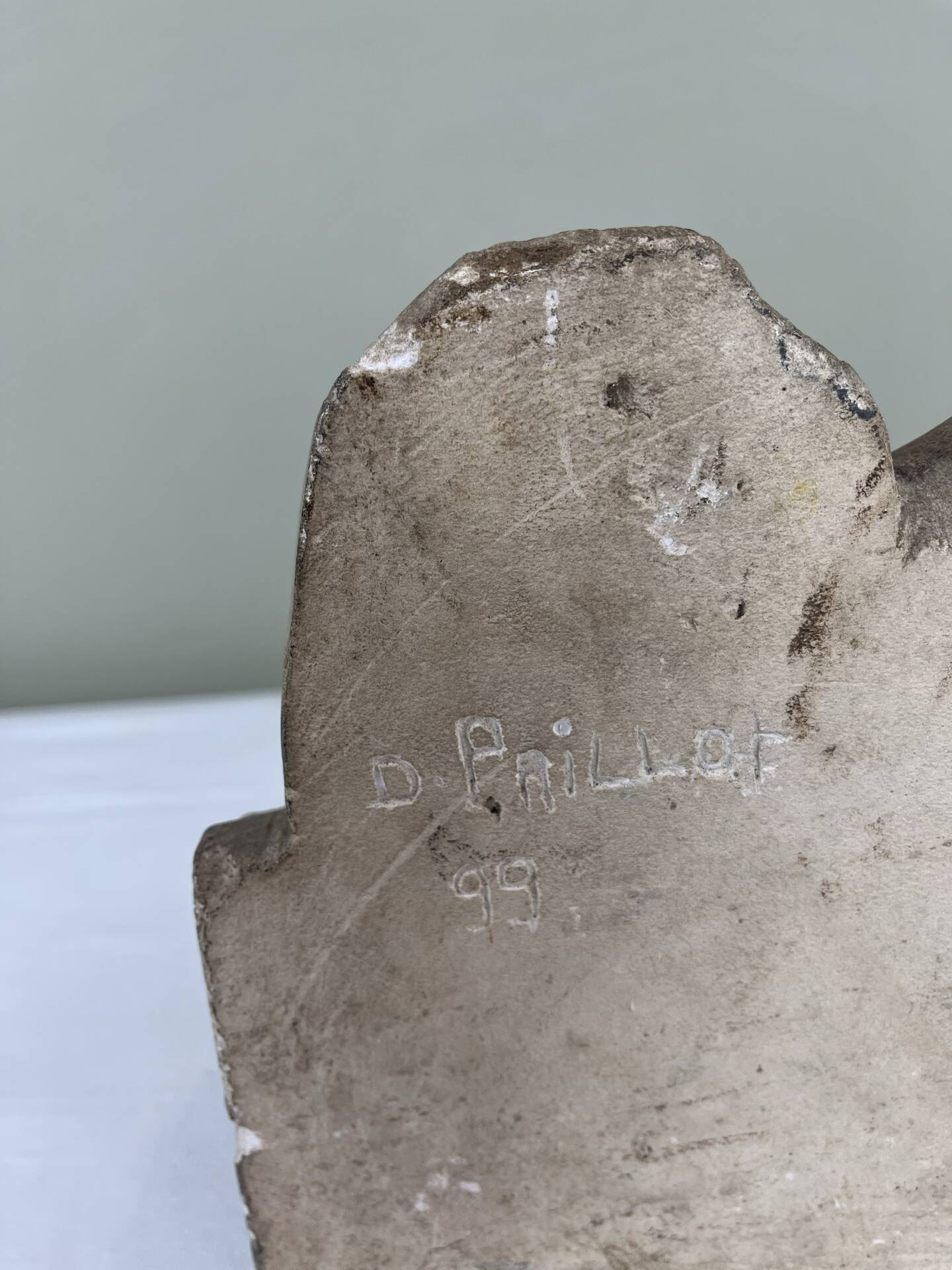 Stone sculpture, two feet on a block, signed D. Paillot.