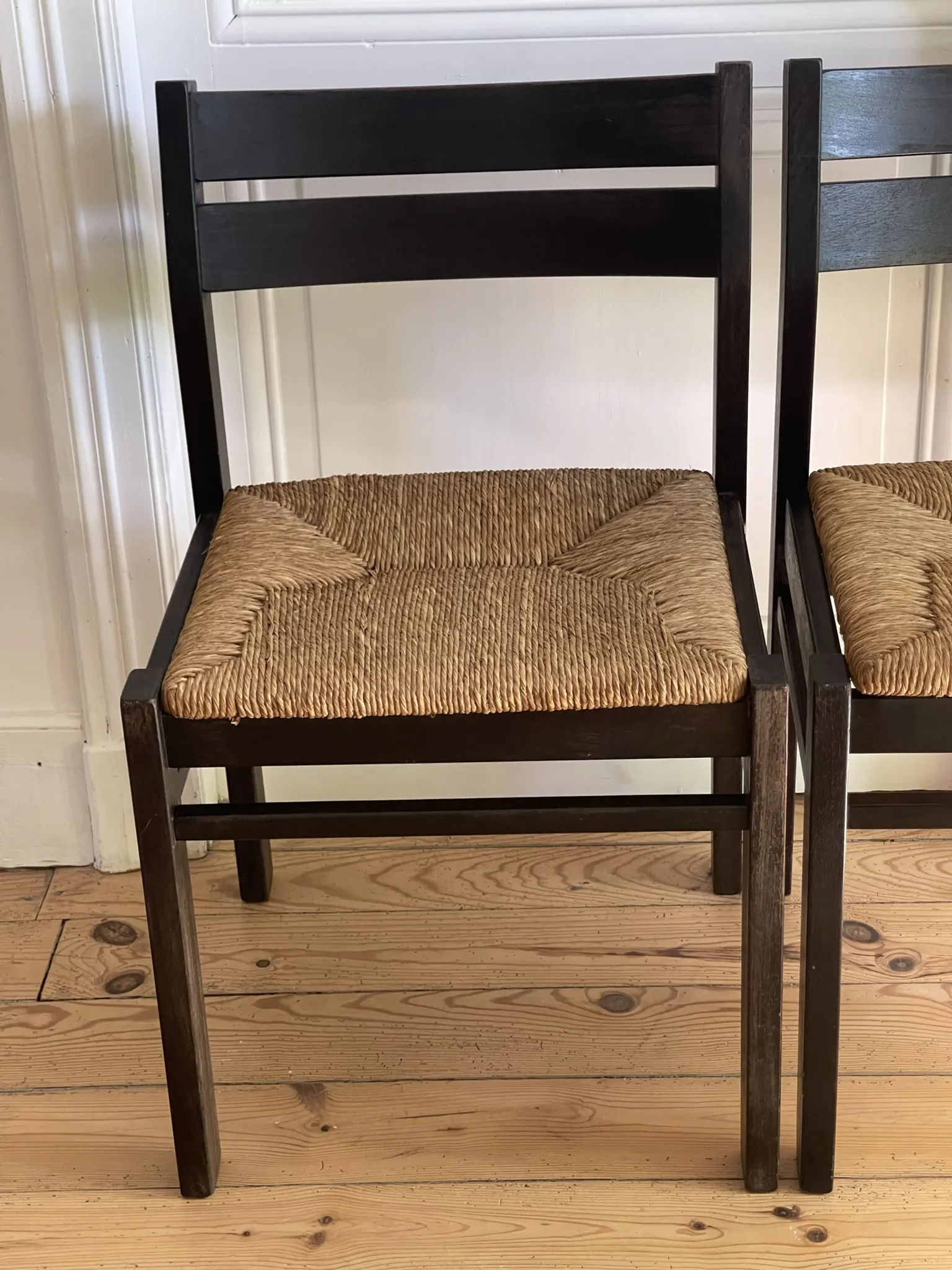 Pair of straw-seated wooden chairs in the regain style.