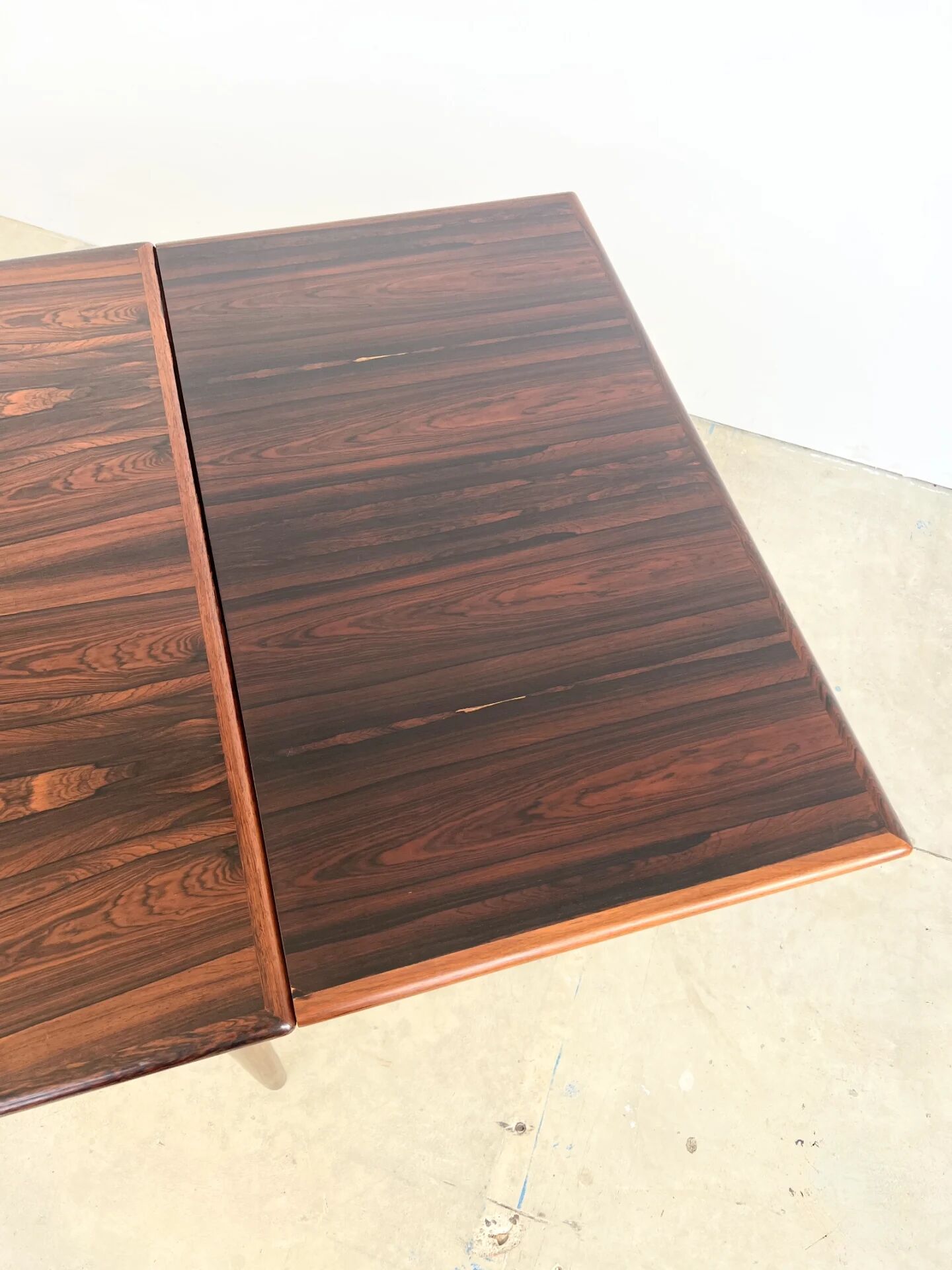 Rosewood dining table with integrated extensions — Denmark, 1960s