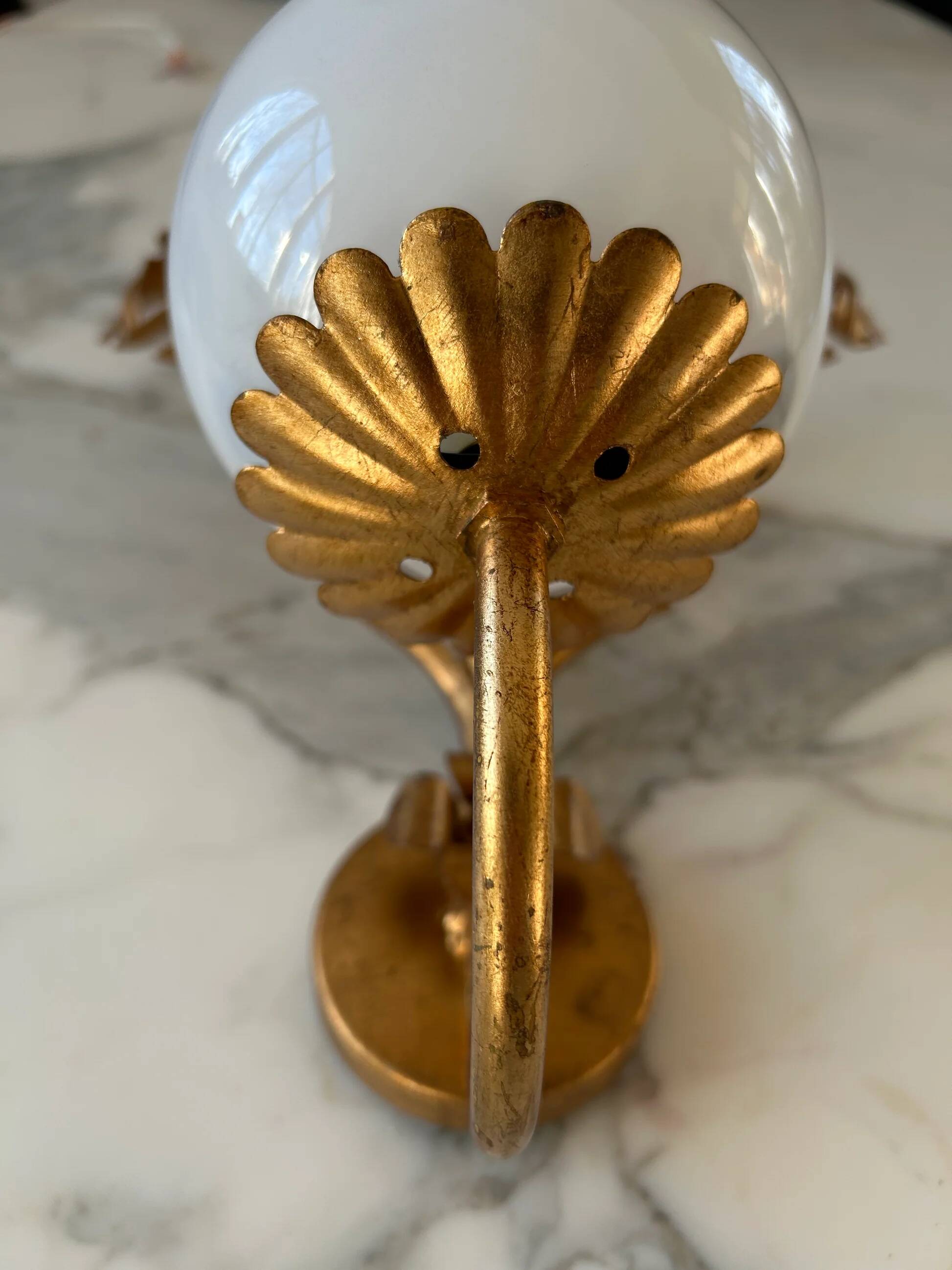 Pair of palm leaf wall lights in Hollywood Regency style with opaque globes by Hans Kögl, Germany, 1970s.