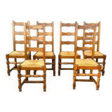 Set of 6 solid wood chairs with straw seats.