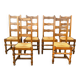 Set of 6 solid wood chairs with straw seats.