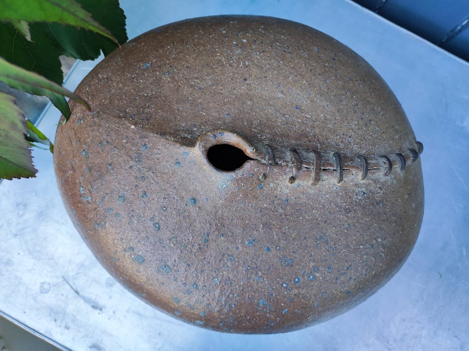 Vintage sandstone vase, in the shape of a rugby ball, signed