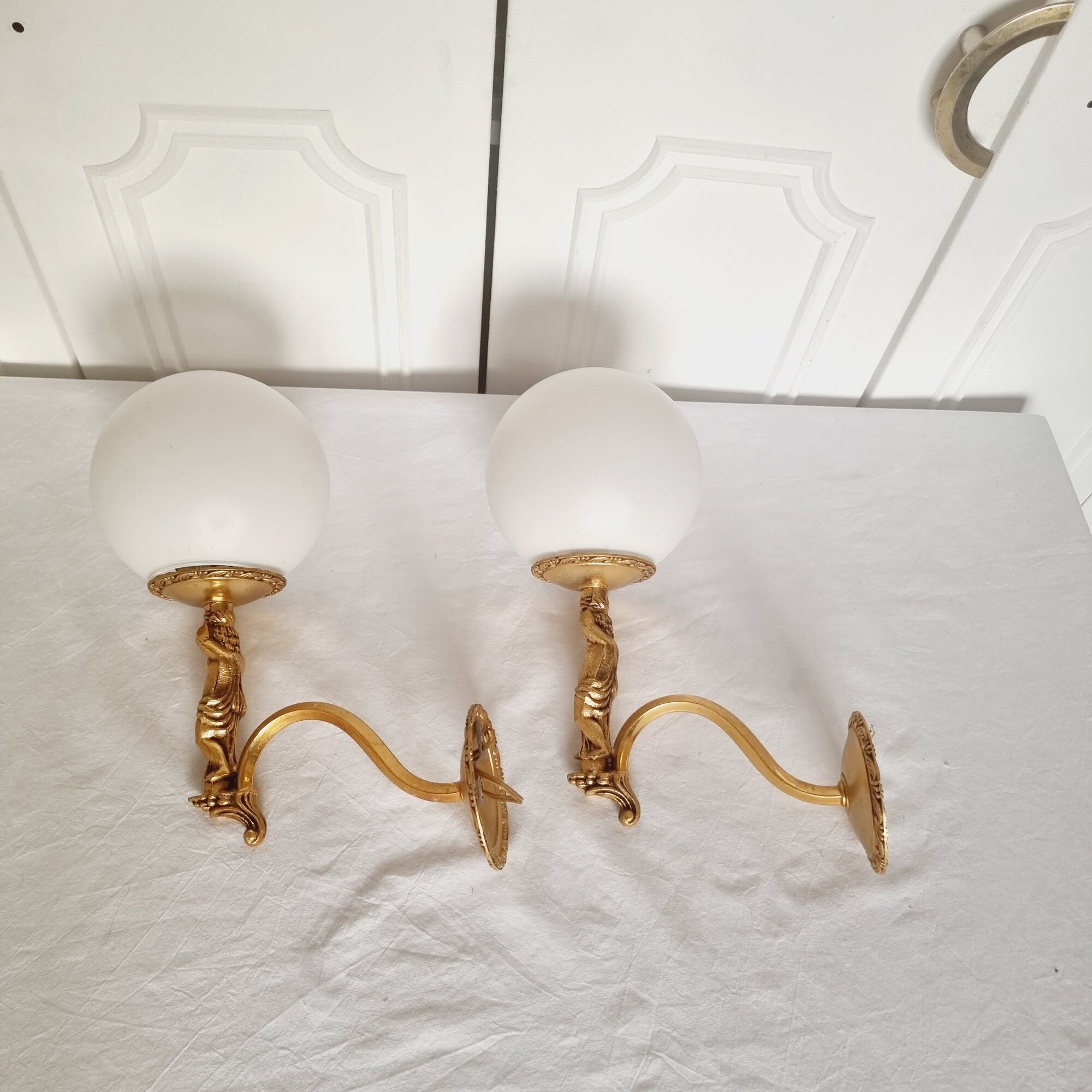 2 classic golden cherub wall lights and globe lampshades in perfect condition.