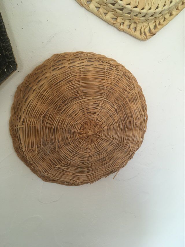 Wall composition of 9 wicker baskets and trays.