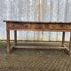 Old chestnut table with 3 front drawers and a cat bar.