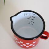 Red enamelled metal milk pot