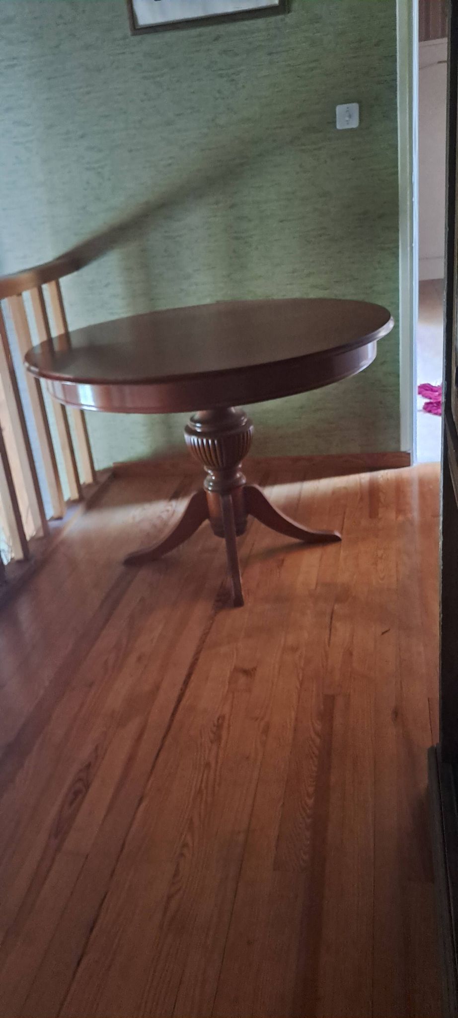 Round solid walnut table with central leg from the 1950s with extensions.