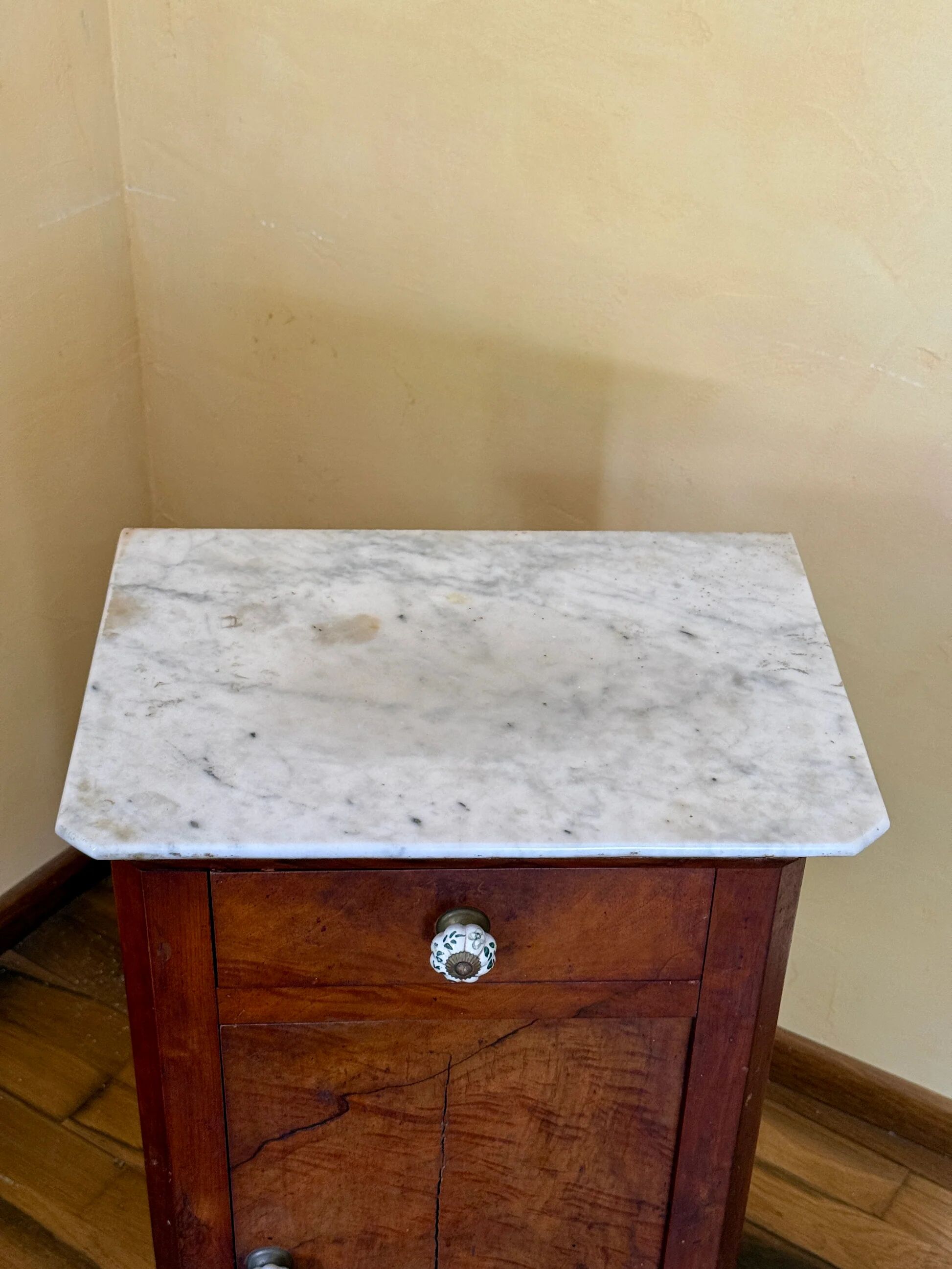 Wood and marble side table with ceramic handles.