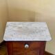 Wood and marble side table with ceramic handles.