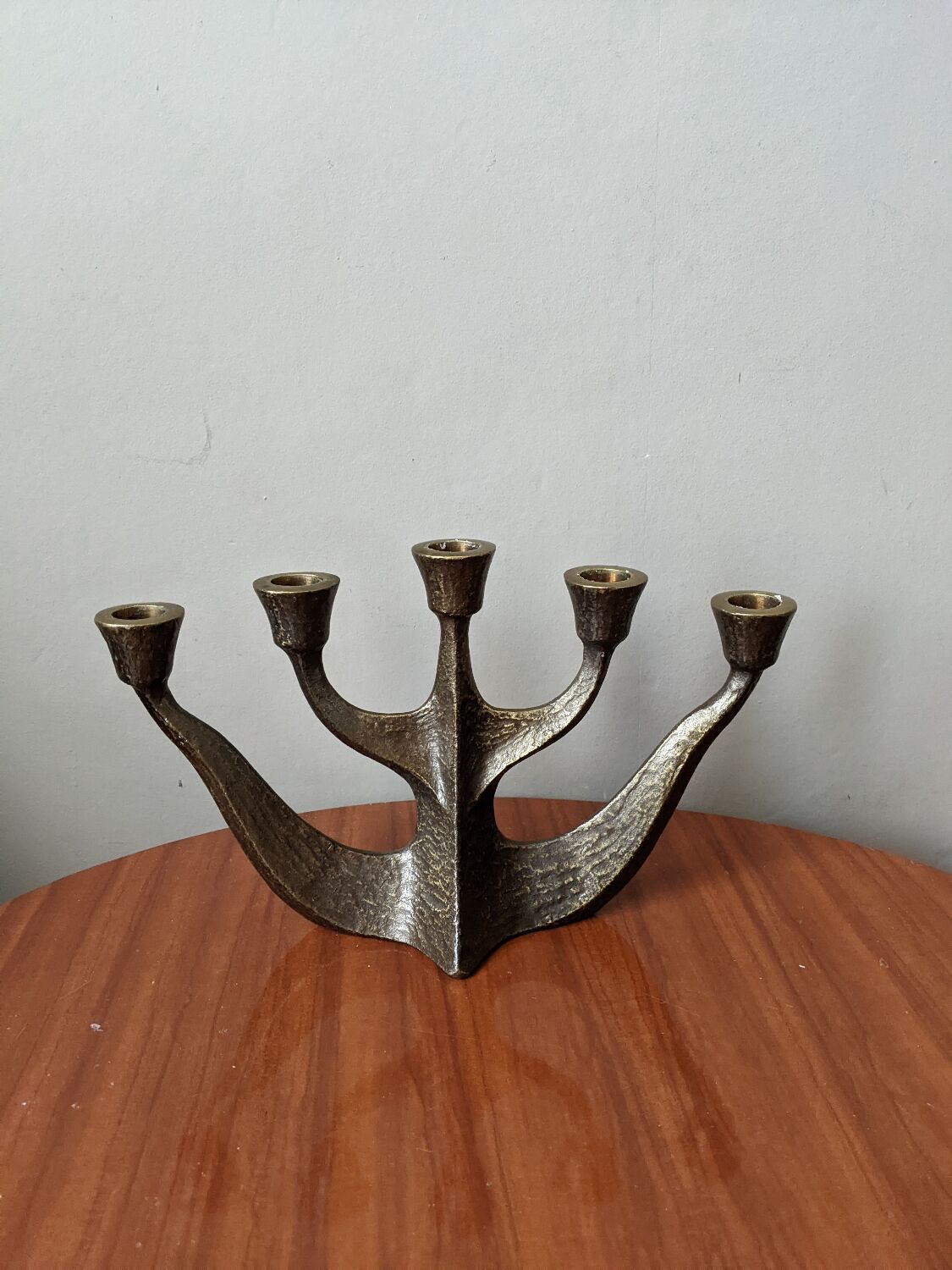 Vintage bronze candlestick chandelier in contemporary Scandinavian design.