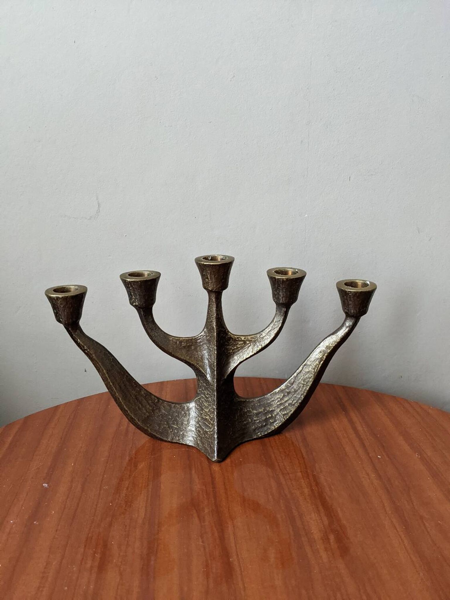 Vintage bronze candlestick chandelier in contemporary Scandinavian design.