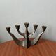 Vintage bronze candlestick chandelier in contemporary Scandinavian design.