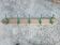 Antique coat rack with 5 hooks.