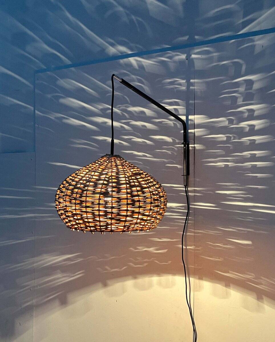 Mid-century modern Danish extendable cantilever wall lamp with a rattan shade, 1960s.