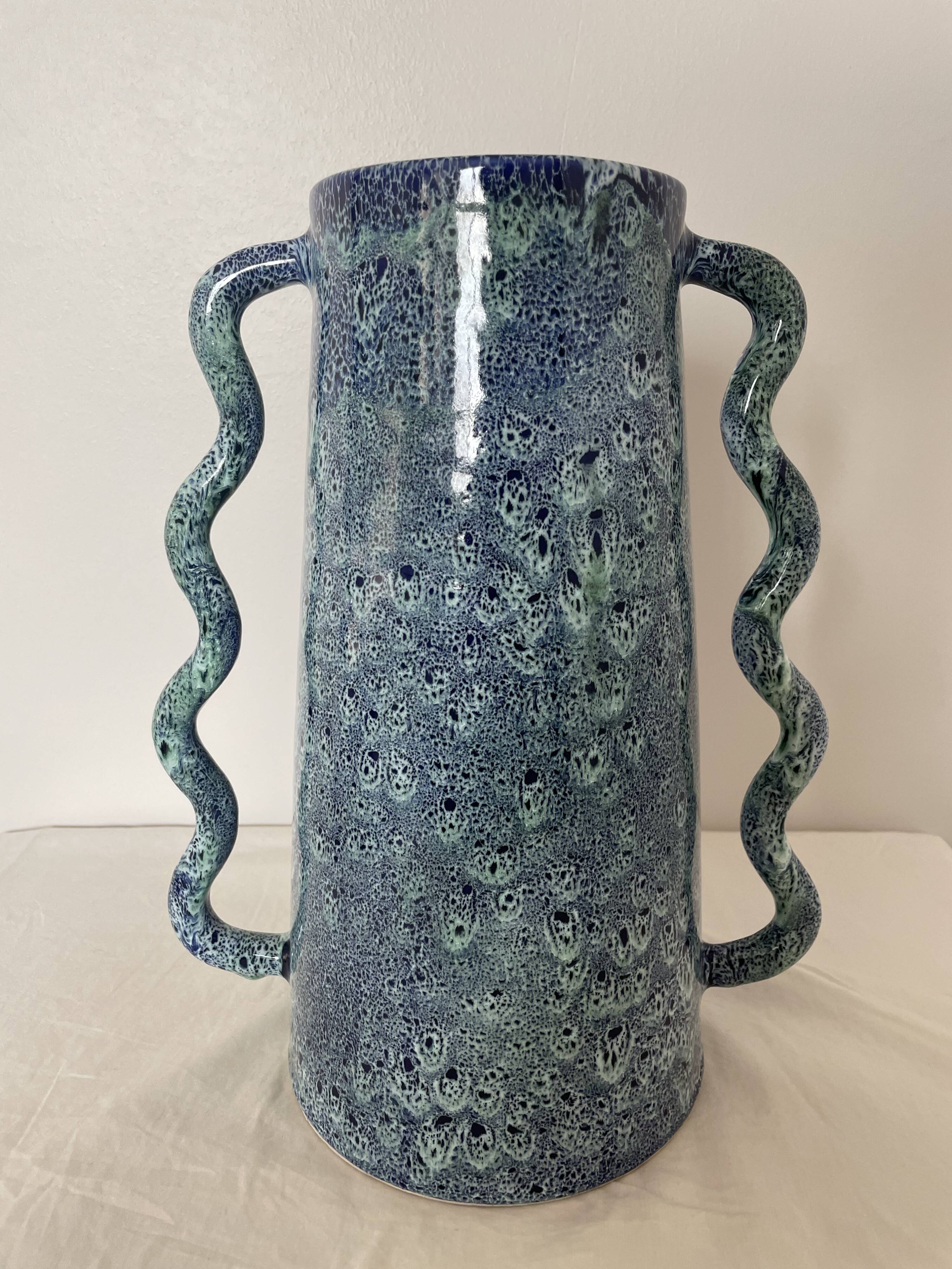 Blue-green ceramic vase with abstract wavy handles