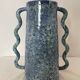 Blue-green ceramic vase with abstract wavy handles
