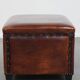 Cognac-colored sheepskin stool with decorative studs