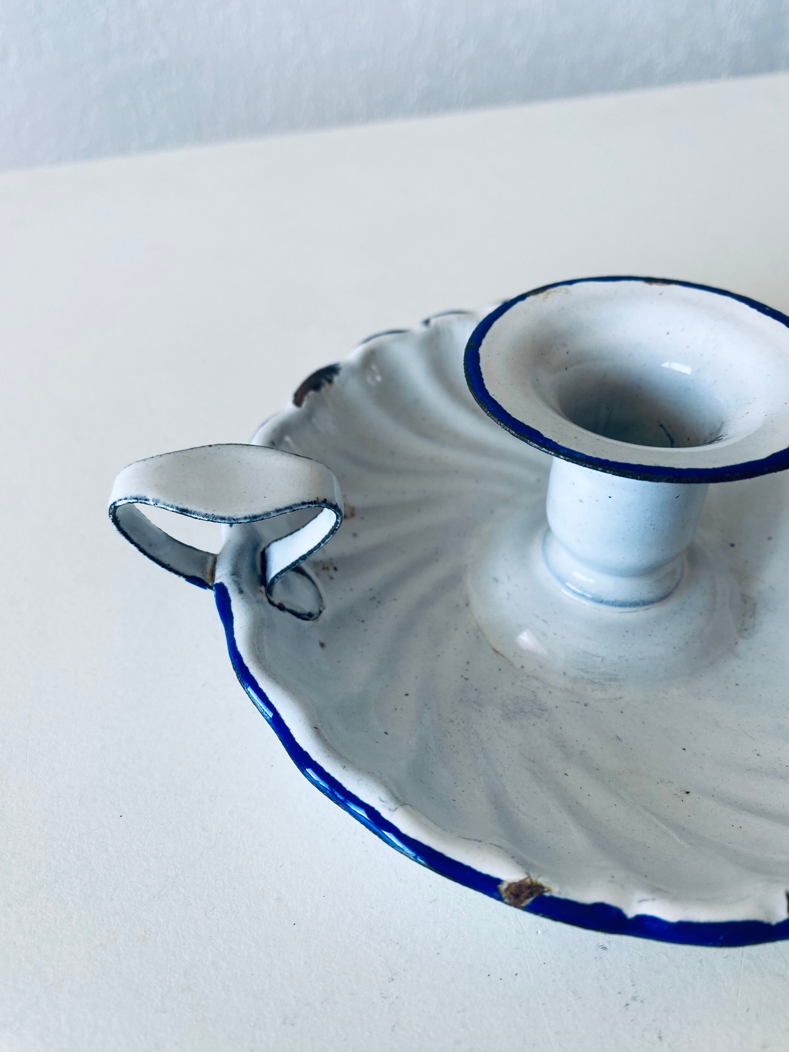 Antique candle holder in white and blue enamelled metal