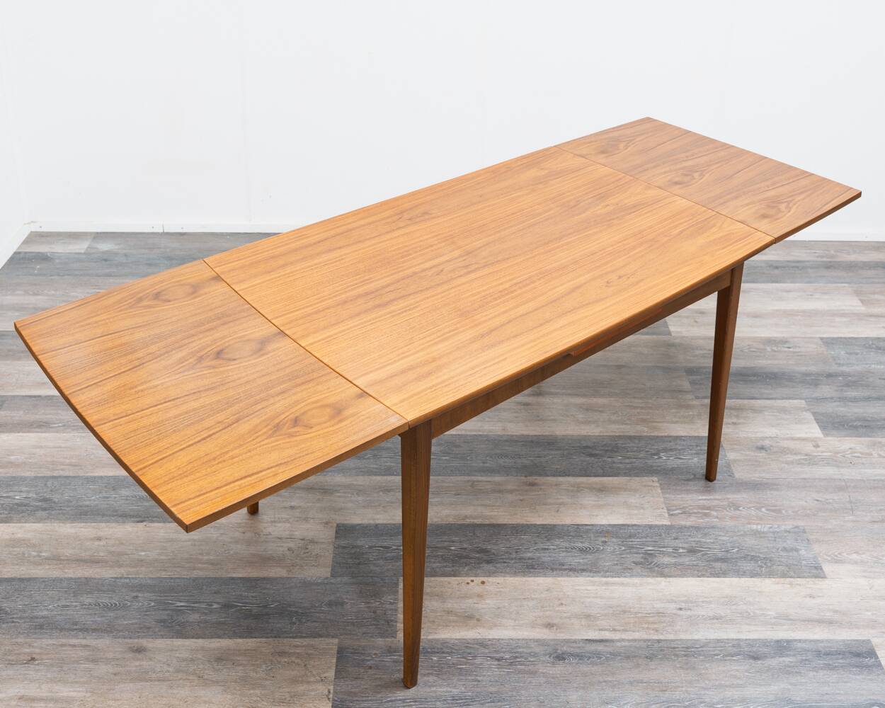 Dining table, 1960s, in walnut, slightly elliptical shape.