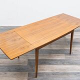 Dining table, 1960s, in walnut, slightly elliptical shape.
