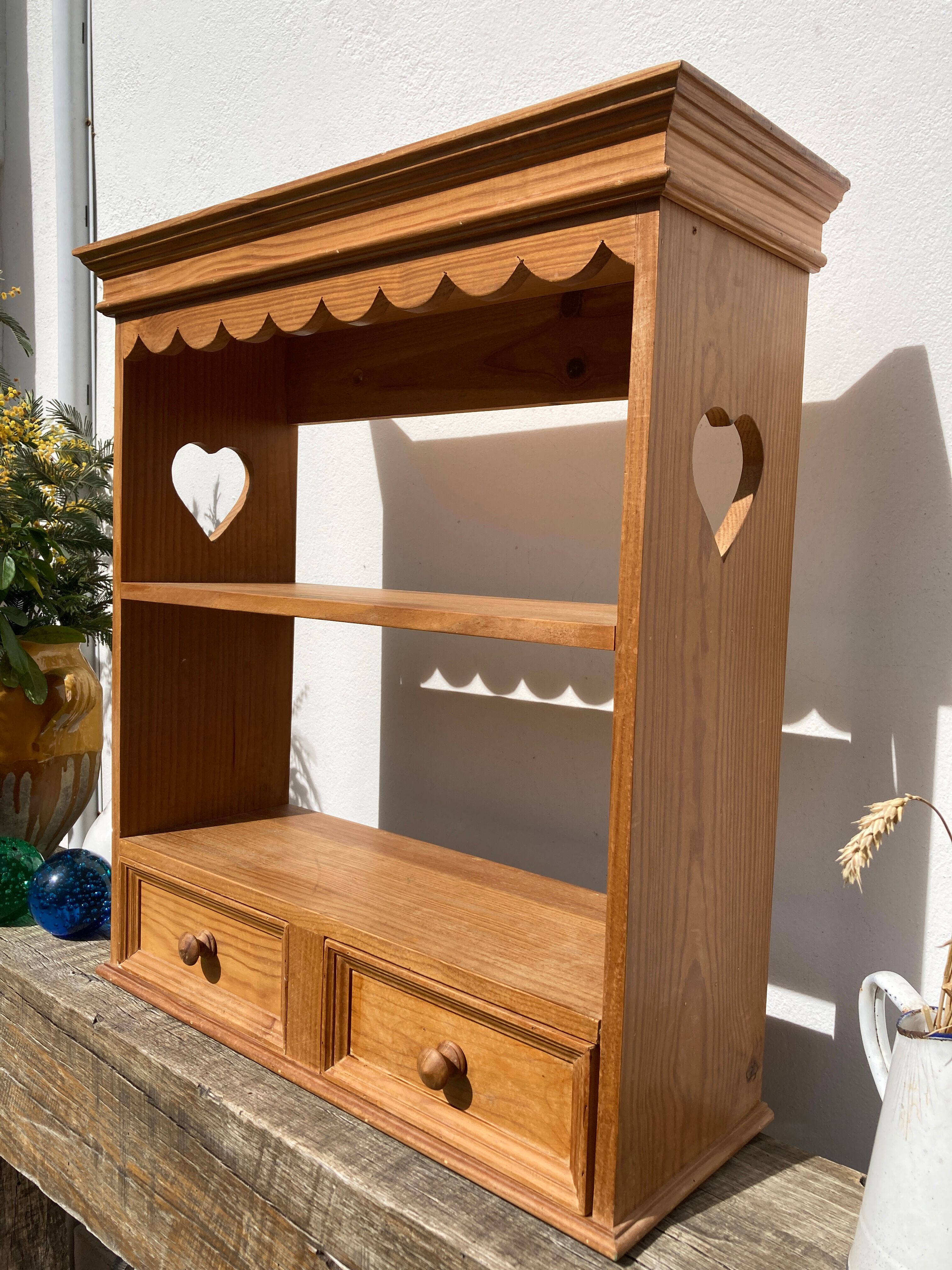 Wall shelf in raw wood with drawers and openwork hearts