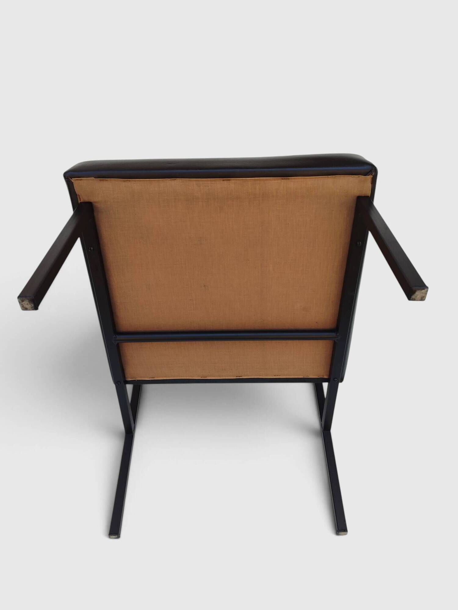 Modernist armchair in black faux leather and metal – 1960s