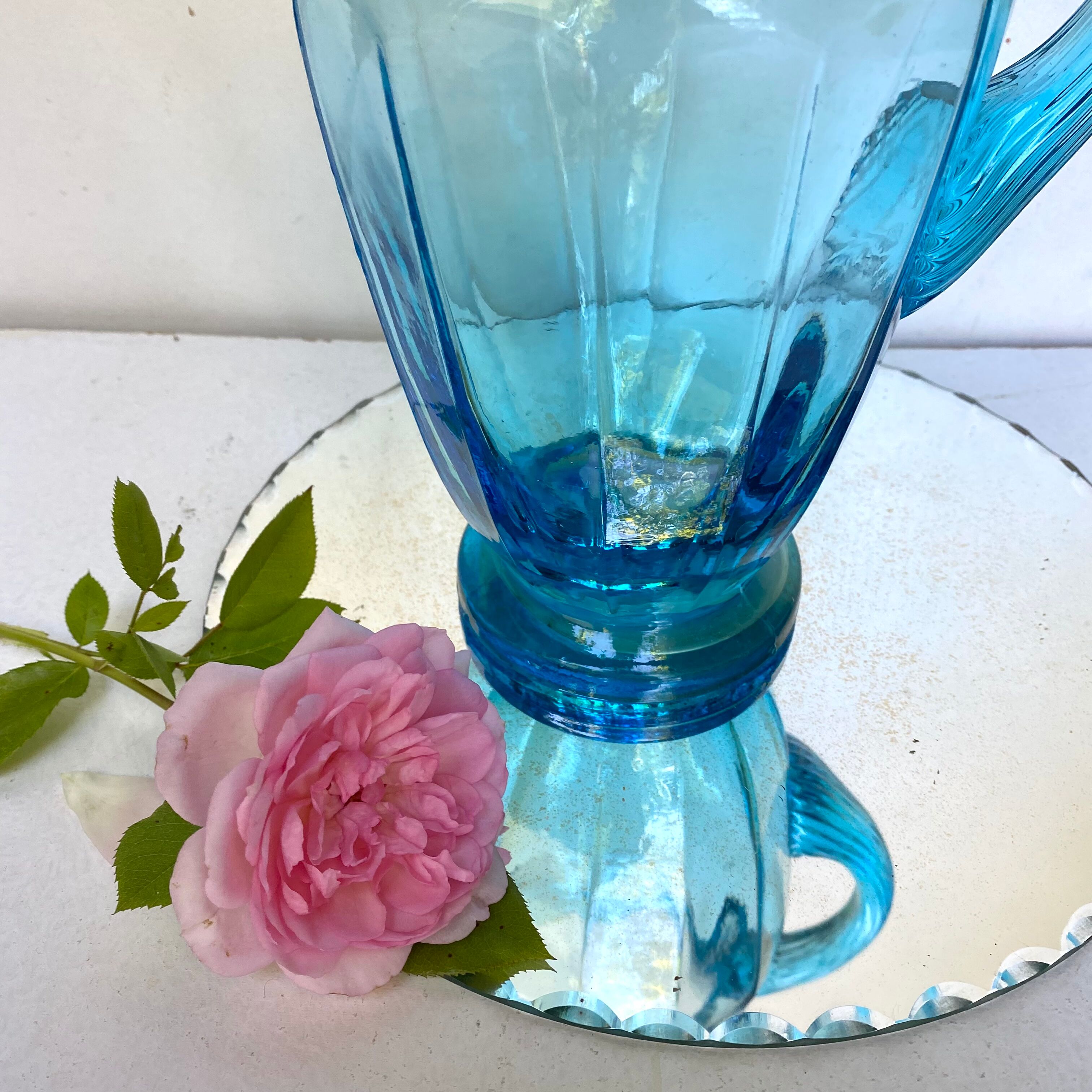 Old pitcher in blue glass