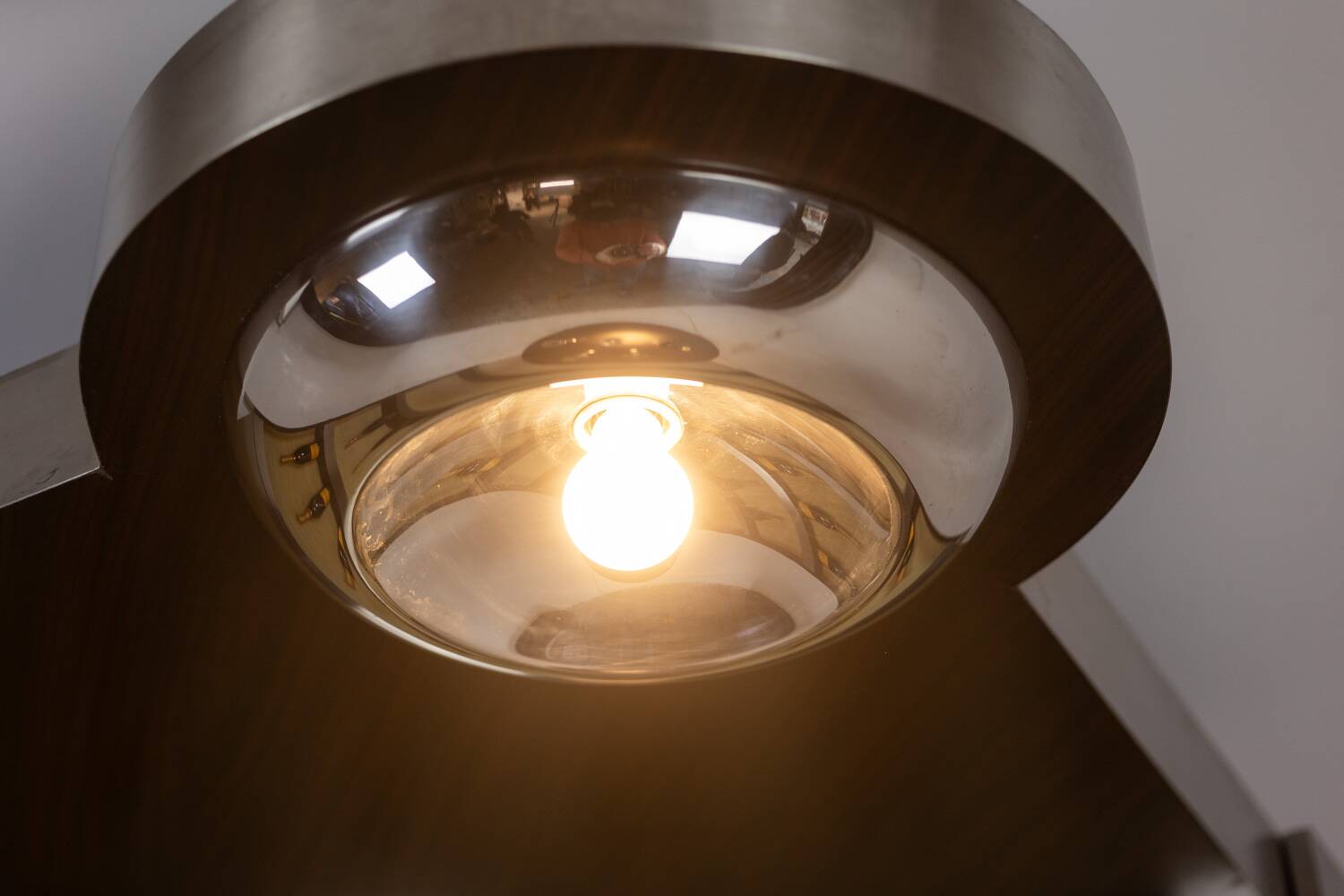 Circular bar in brushed metal, wood and carpet. 1970s.