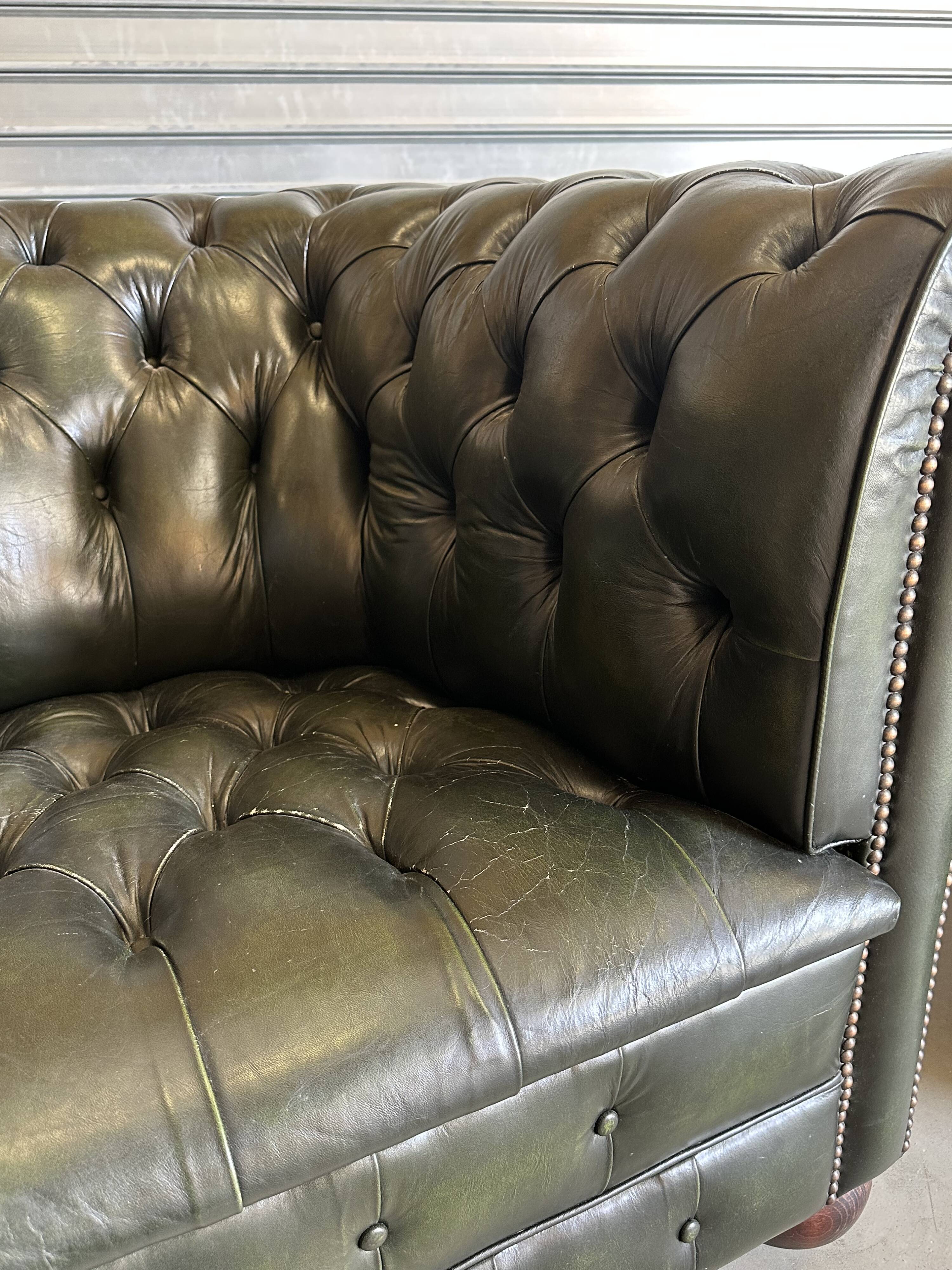 Title: Pair of vintage olive green leather Chesterfield armchairs