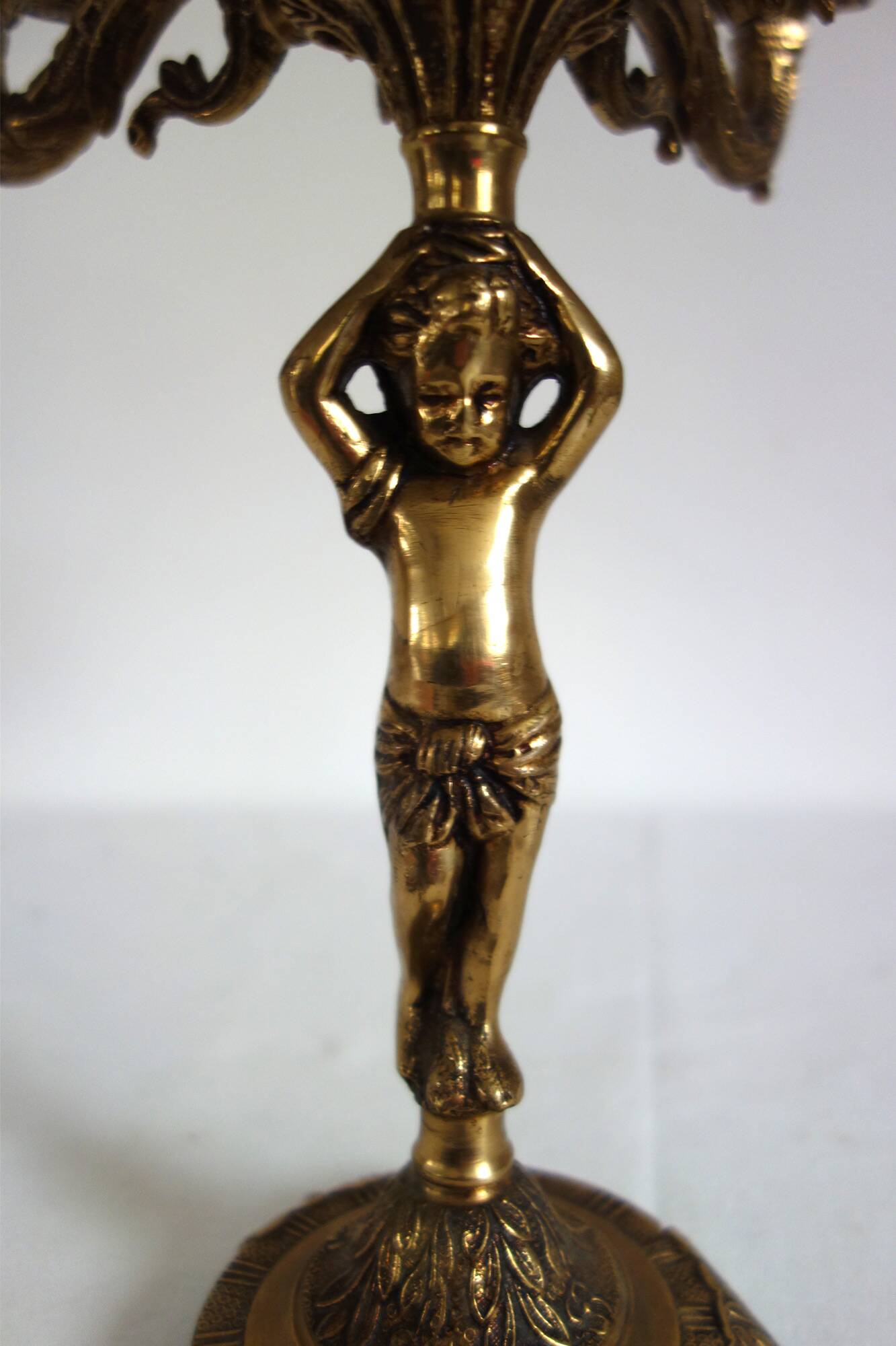 Pair of cherub candle holders in gilded bronze, early 20th century.