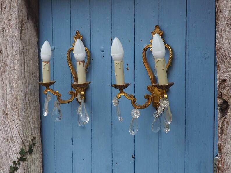 French antique Louis XV style twin arm wall sconces in bronze with crystals.