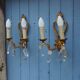 French antique Louis XV style twin arm wall sconces in bronze with crystals.