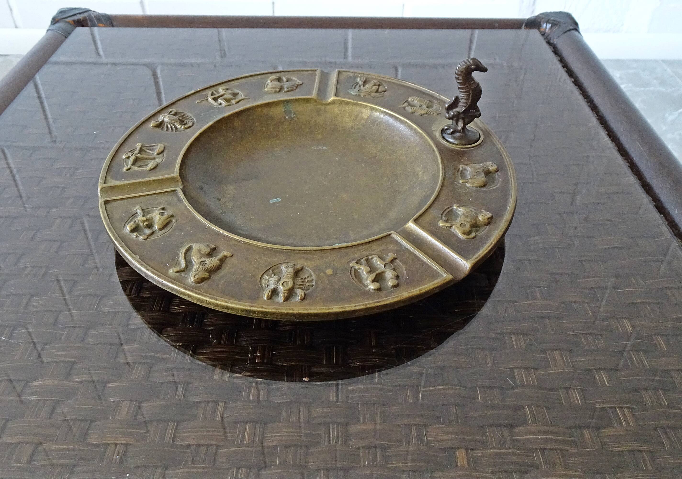 Luxa brass ashtray with zodiac relief and embers killer