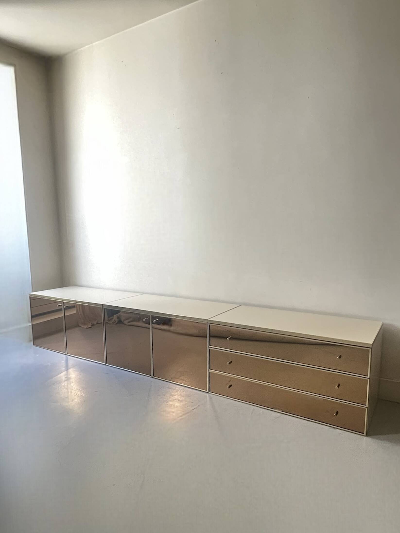 Ivory lacquered sideboard with polished finish and smoked mirror, JC Mahey design 1970.