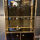 Hollywood Regency style bookcase shelf, gilded brass and black lacquered wood, 1970