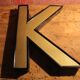 Teaches letter K vintage gold outlined in black format 15 x 21 cm