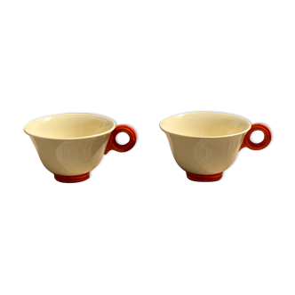 Two old orange handle cups