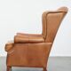 Fauteuil à oreilles en cuir de vache