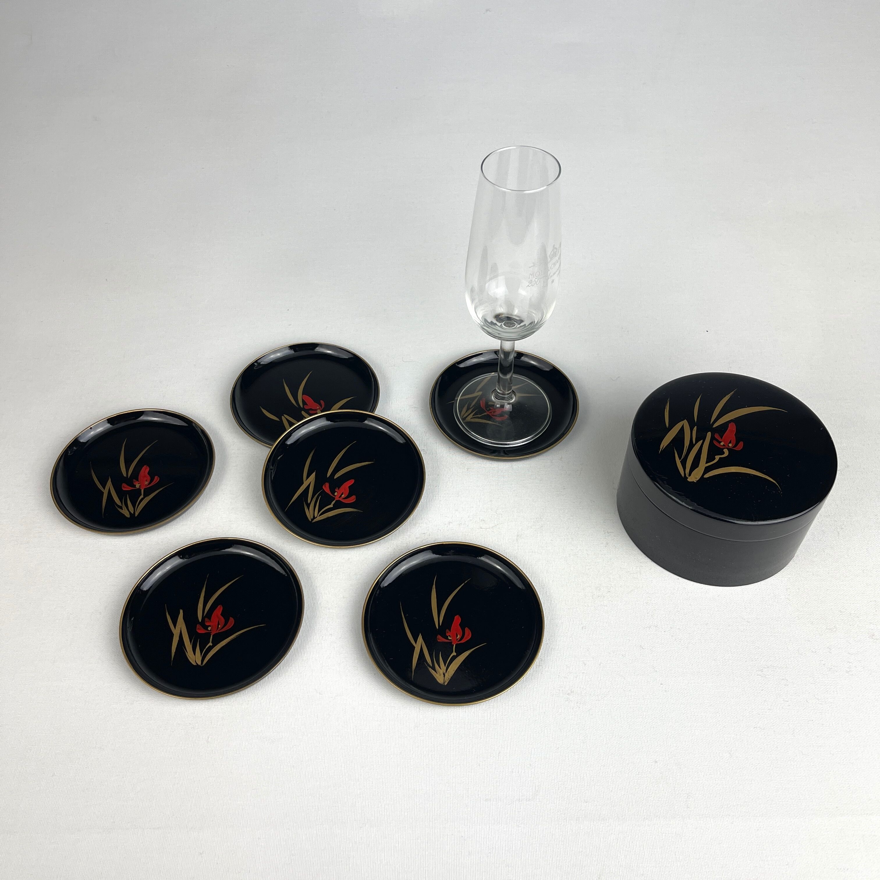 Coasters and their vintage black lacquered wooden box