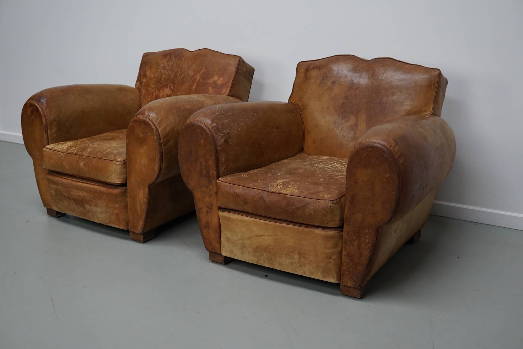 Pair of French club chairs with moustache back in cognac leather, 1940s