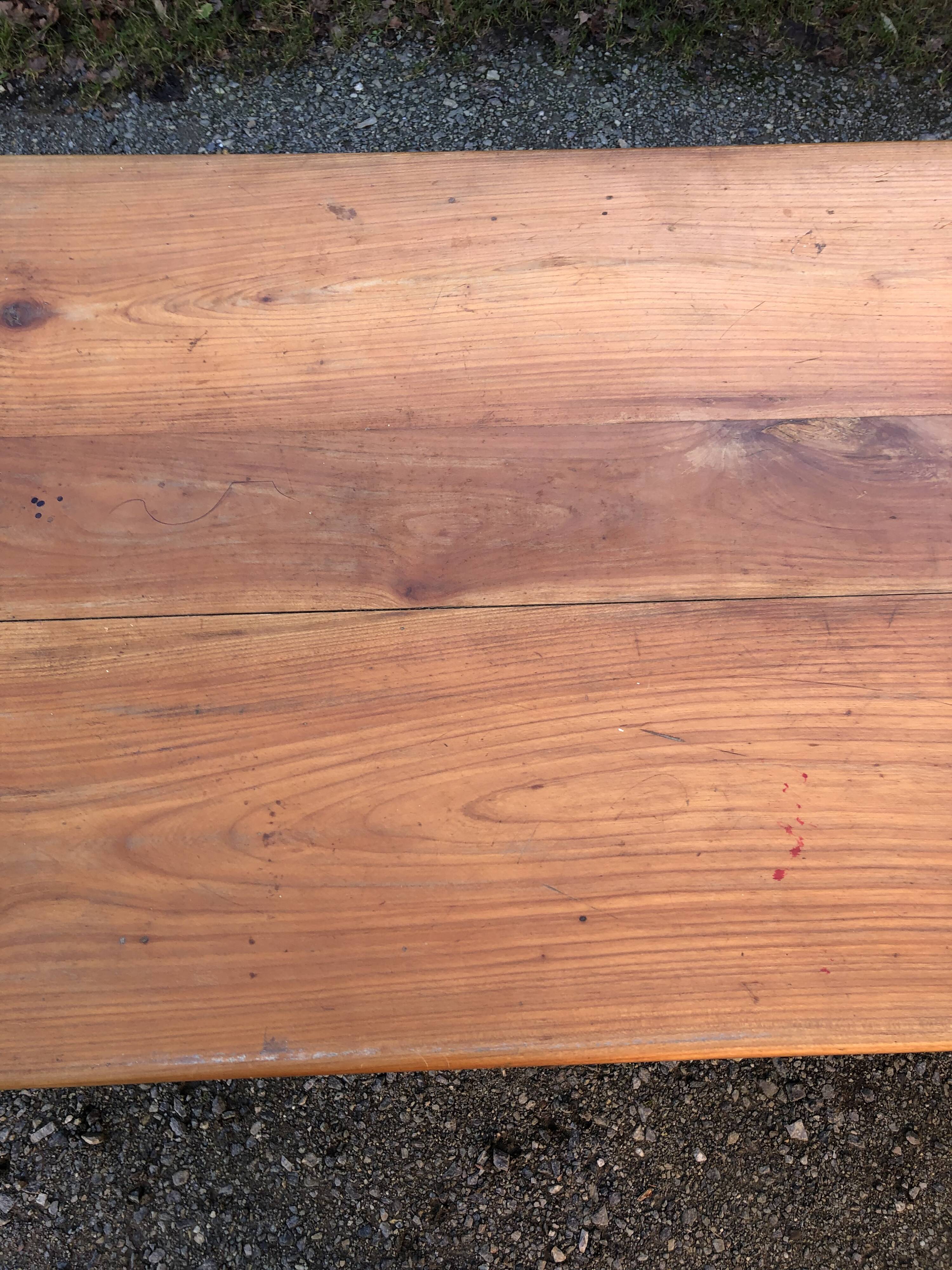 Antique cherry farmhouse table with turned legs and 2 drawers.