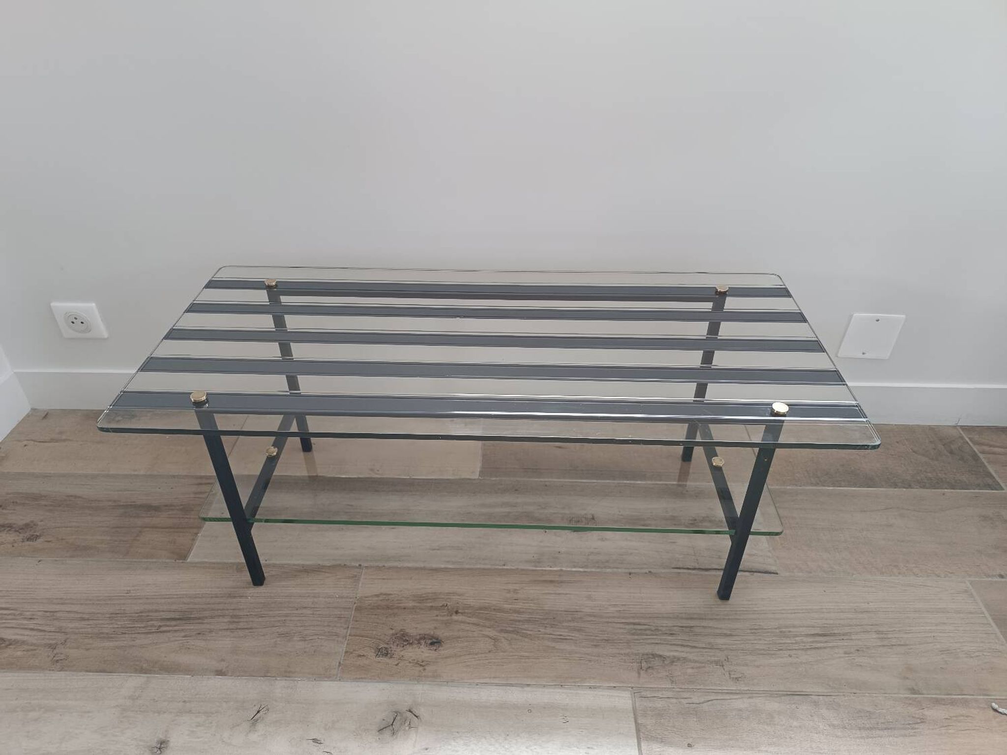Vintage coffee table in glass and mirror strips.